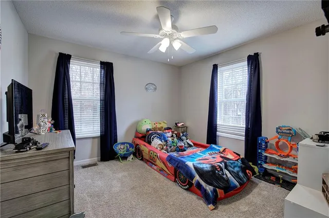 a bedroom with furniture and a flat screen tv