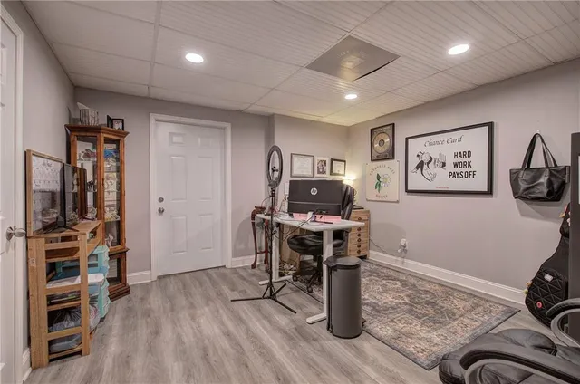 a view of a workspace with furniture and a window