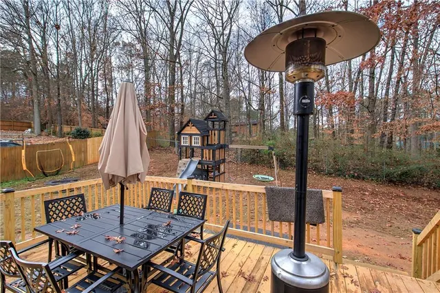 a view of a chairs and table in backyard