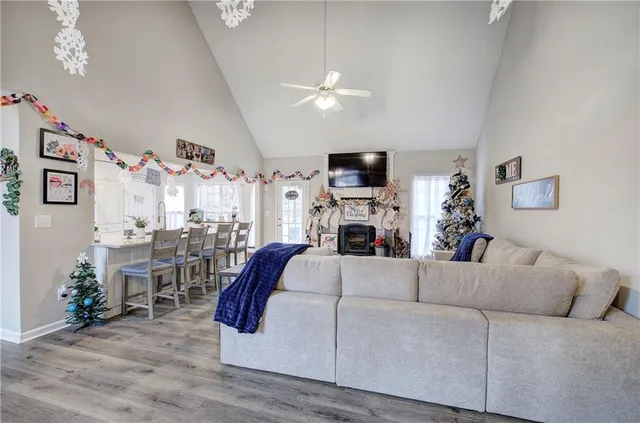 a living room with furniture a fireplace and a flat screen tv