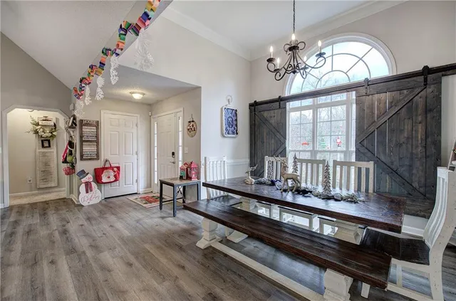 a very nice looking room with wooden floor and furniture