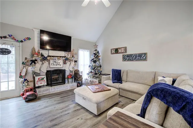 a living room with furniture a flat screen tv and a fireplace