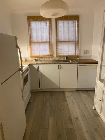 a kitchen with granite countertop a sink a window and stainless steel appliances