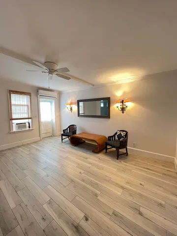 a view of a livingroom with a couch and wooden floor
