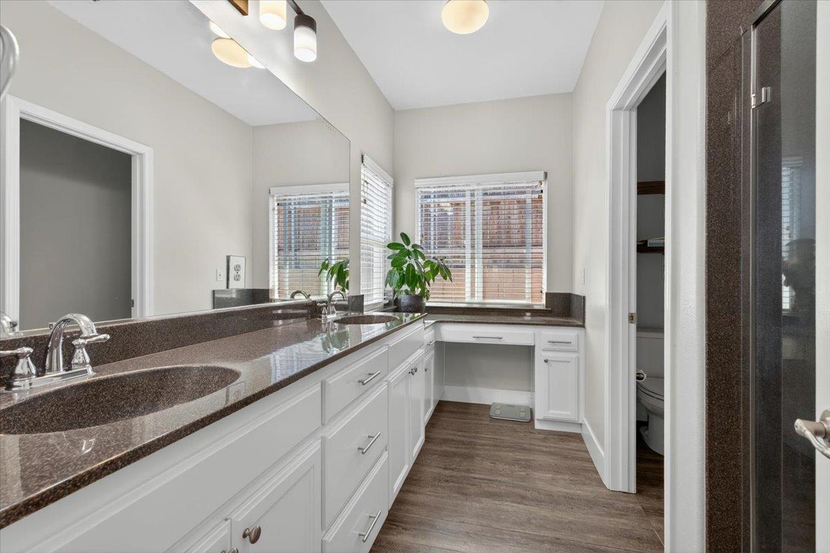 437 Silver Ridge Court Oakdale, CA 95361 - Photo 21 of 41 a bathroom with double vanity sinks a vanity and a large mirror