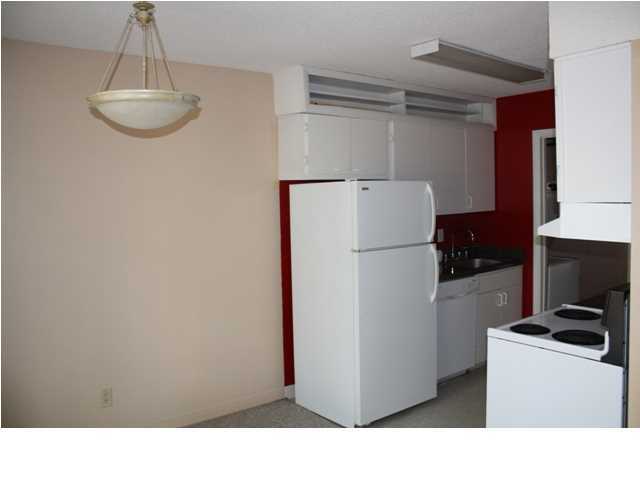 210 Pelham Road, Unit A207 Fort Walton Beach, FL 32547 - Photo 5 of 10 a kitchen with refrigerator and microwave