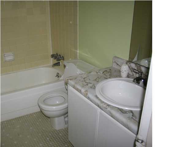 210 Pelham Road, Unit A207 Fort Walton Beach, FL 32547 - Photo 9 of 10 a bathroom with a sink toilet and shower