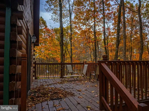 a view of a balcony with wooden fence and floor