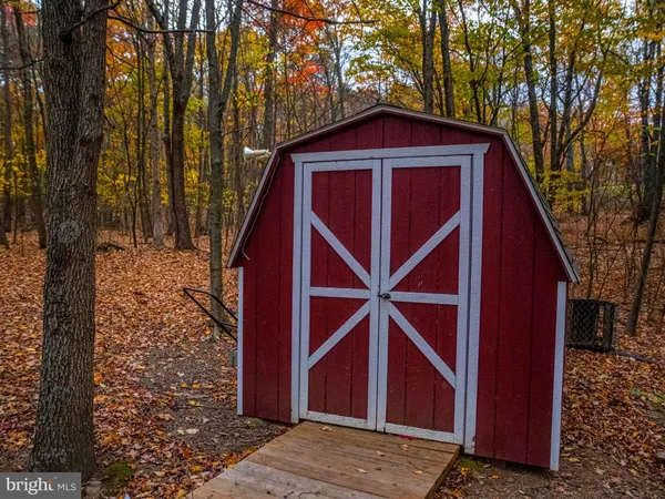 a view of a small house with backyard