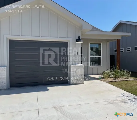 a front view of a house with garage