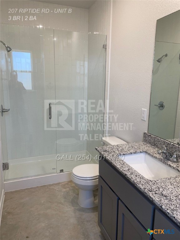 207 Riptide Road Temple, TX 76501 - Photo 13 of 13 a bathroom with a granite countertop sink a toilet a mirror and bathtub
