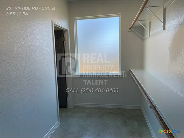 a view of an empty room with a window