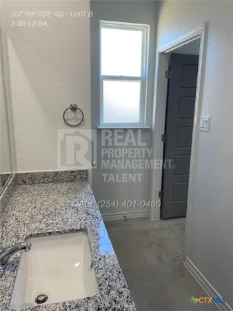 a bathroom with a sink and a shower