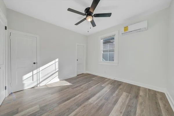 a view of empty room with wooden floor