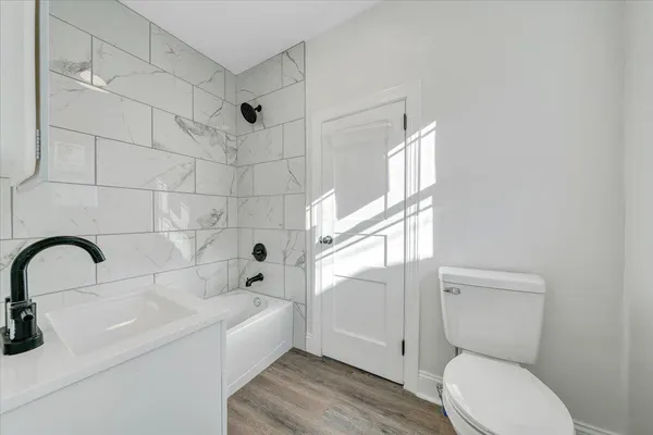 a bathroom with a sink toilet and shower