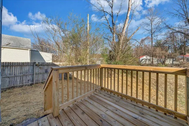 a view of balcony with wooden floor and fence