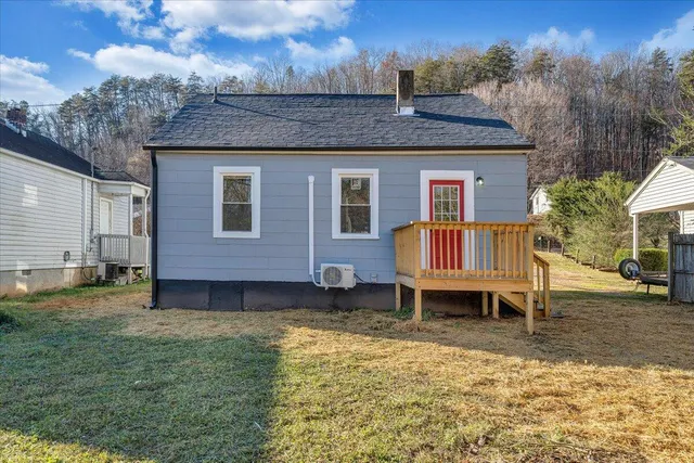 a backyard of a house with barbeque oven table and chairs
