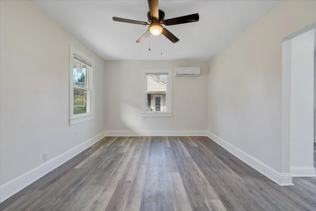 wooden floor in an empty room with a window