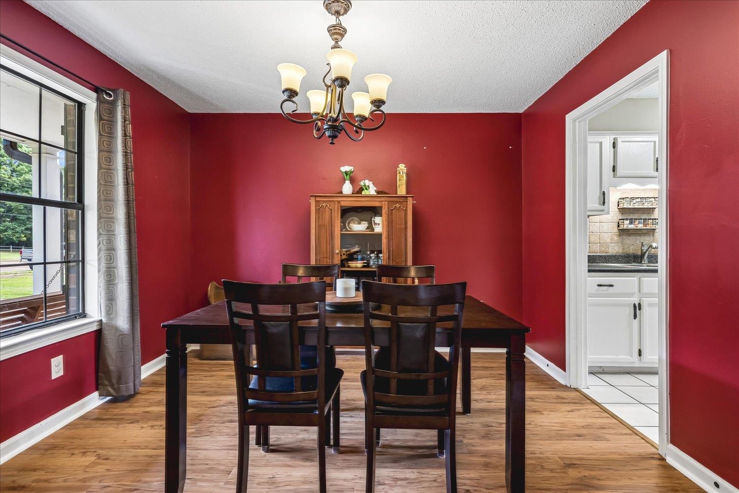 5711 Yale Road Bartlett, TN 38134 - Photo 11 of 29 Dining area featuring wood-finish flooring, a multi-light chandelier, and a window with exterior views