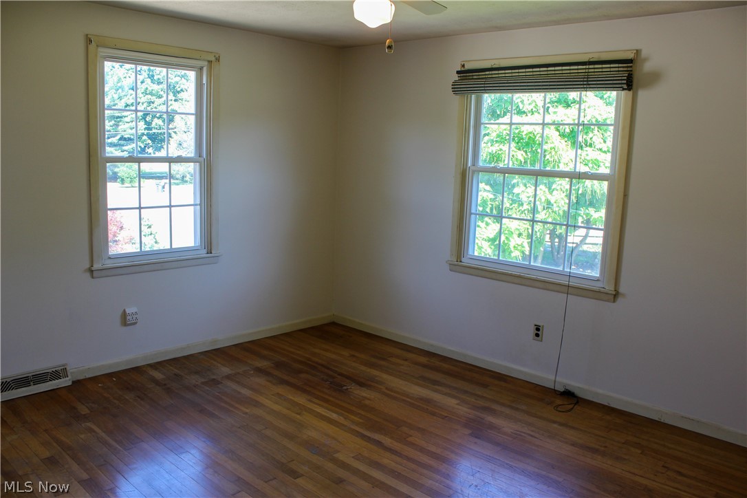 11910 West Lake Road Vermilion, OH 44089 - Photo 17 of 28 Bedroom with natural hardwood flooring and a healthy amount of sunlight
