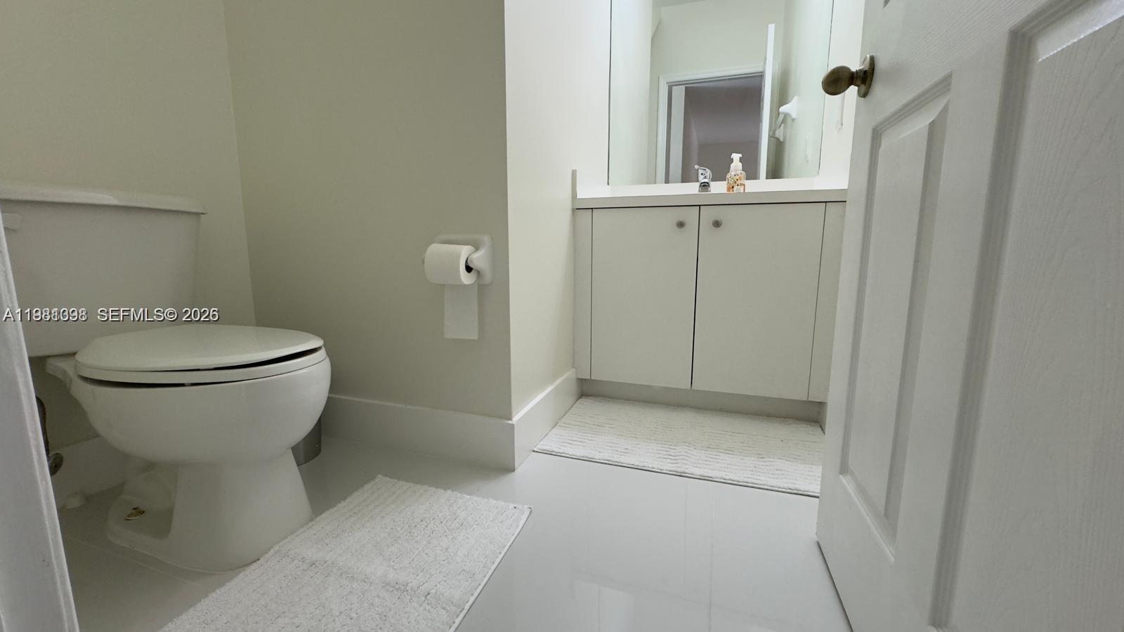 949 Northeast 42nd Avenue Homestead, FL 33033 - Photo 13 of 17 a bathroom with a toilet sink and mirror