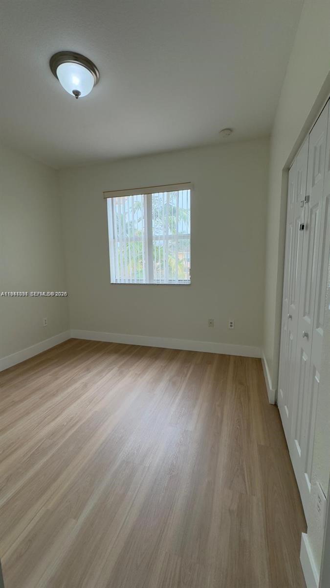 949 Northeast 42nd Avenue Homestead, FL 33033 - Photo 15 of 17 an empty room with wooden floor and windows