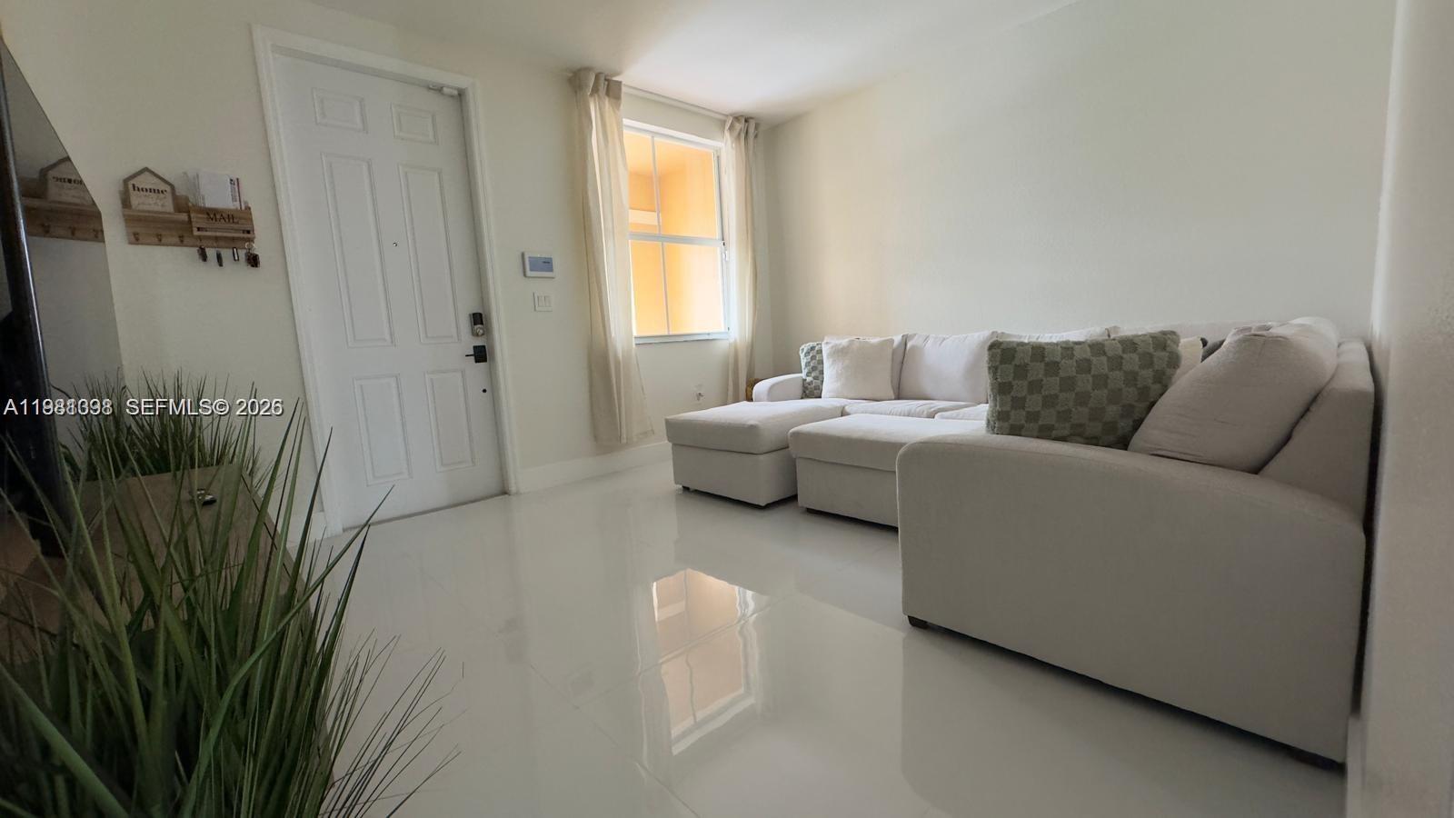 949 Northeast 42nd Avenue Homestead, FL 33033 - Photo 3 of 17 a living room with furniture and a window