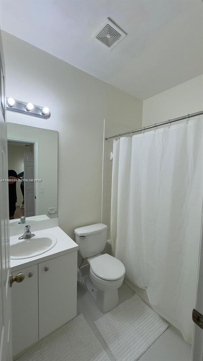 949 Northeast 42nd Avenue Homestead, FL 33033 - Photo 8 of 17 a bathroom with a sink a toilet a mirror and shower