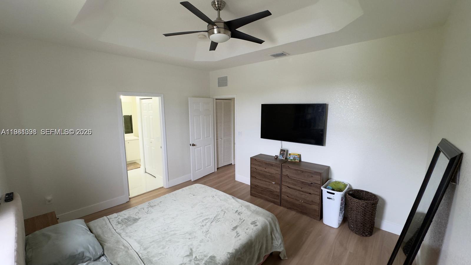 949 Northeast 42nd Avenue Homestead, FL 33033 - Photo 9 of 17 a bedroom with a bed and a flat screen tv