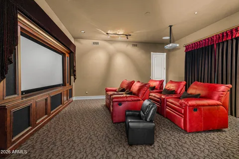 a living room with furniture a flat screen tv and gym equipment