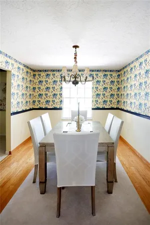 a dining room with furniture and wooden floor