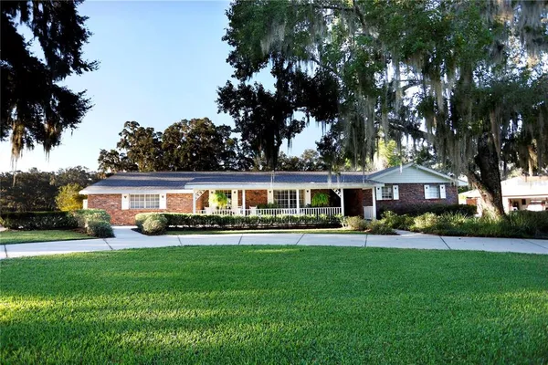 a front view of house with yard and green space