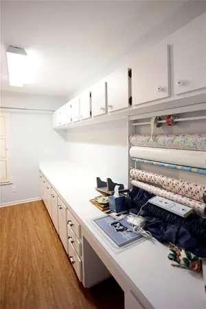 a bathroom with a sink a vanity and a blue mirror