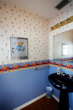 a bathroom with a sink toilet and mirror