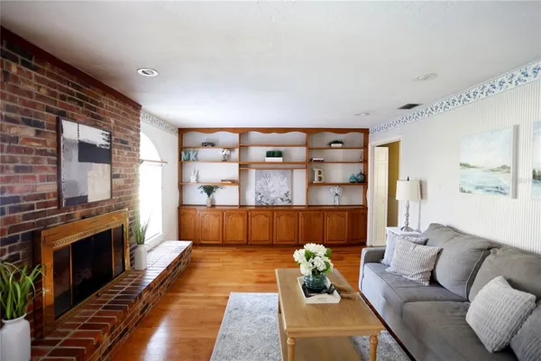 an empty room with a chandelier fan and windows