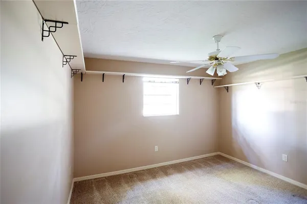 a front view of a house with a garden and trees