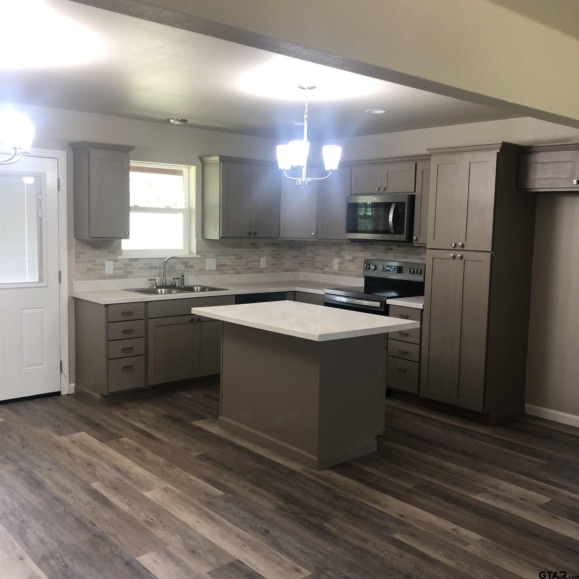 105 Meadows Lane Maud, TX 75567 - Photo 17 of 19 a kitchen with a sink a stove a refrigerator and a stove