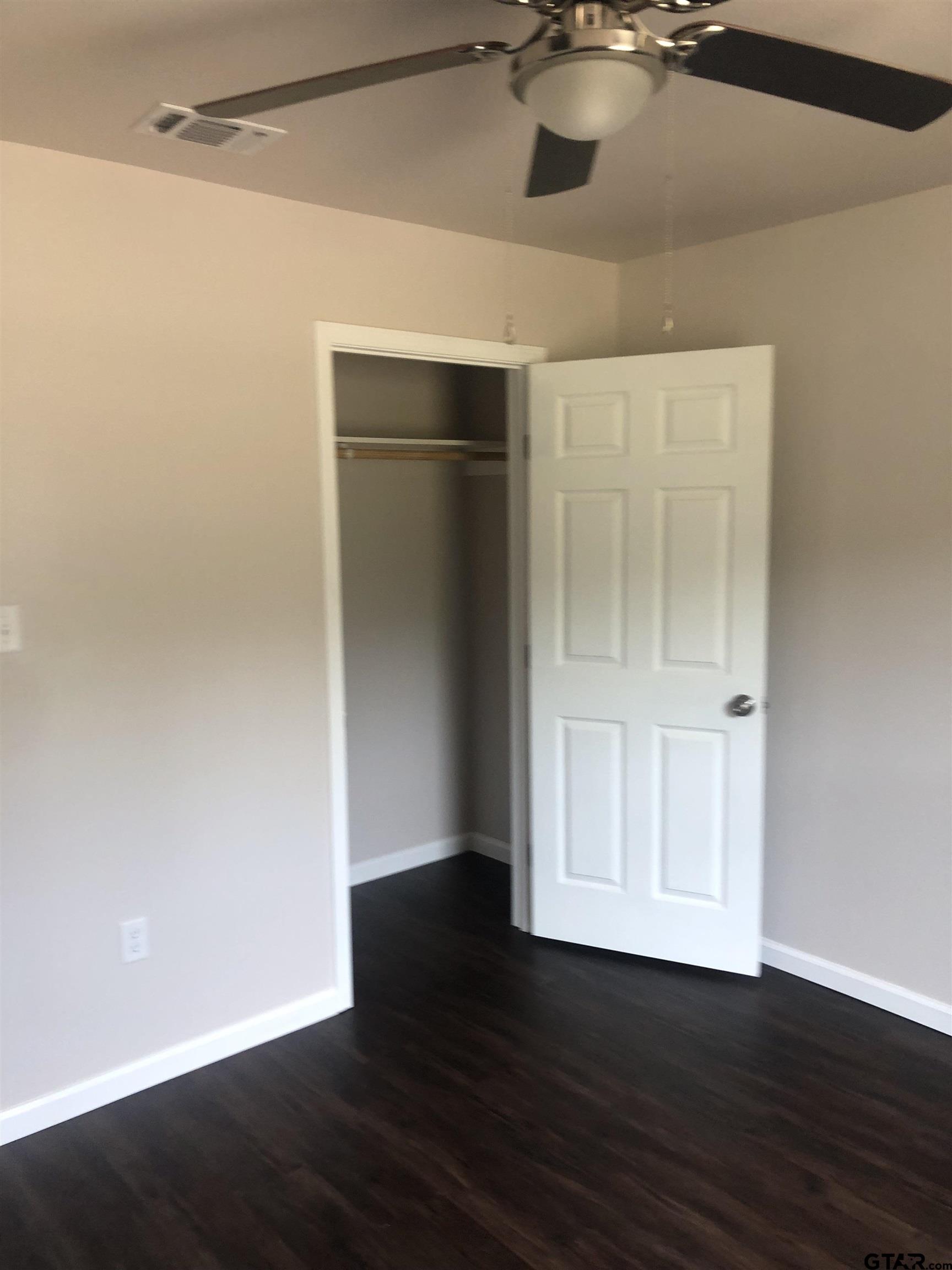 105 Meadows Lane Maud, TX 75567 - Photo 18 of 19 a view of an empty room with wooden floor