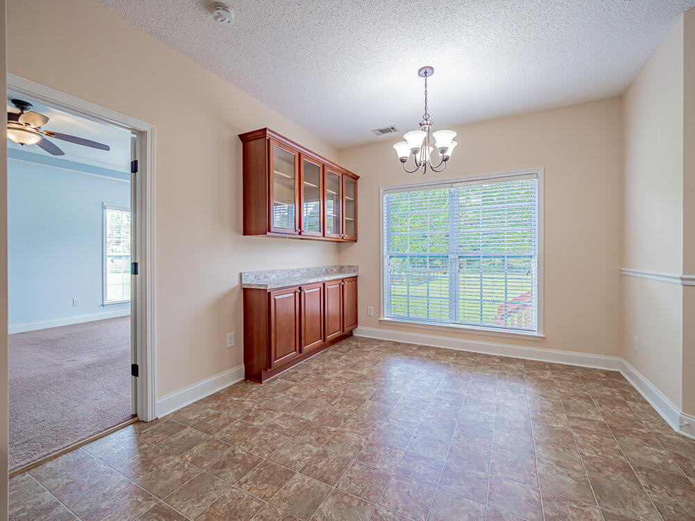 3422 Rev. J. W. Carter Road Summerton, SC 29148 - Photo 11 of 43 Breakfast nook with cabinet and looking over backyard