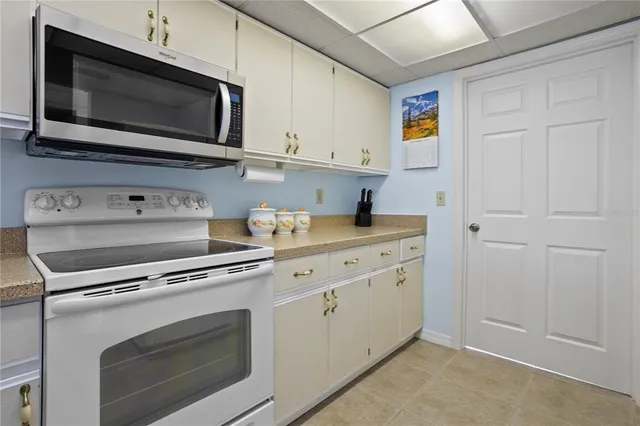 a kitchen with white cabinets stainless steel appliances and sink