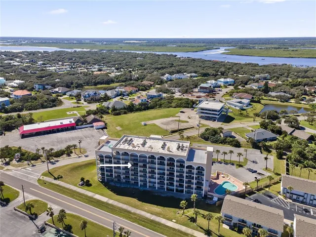 an aerial view of residential houses with outdoor space