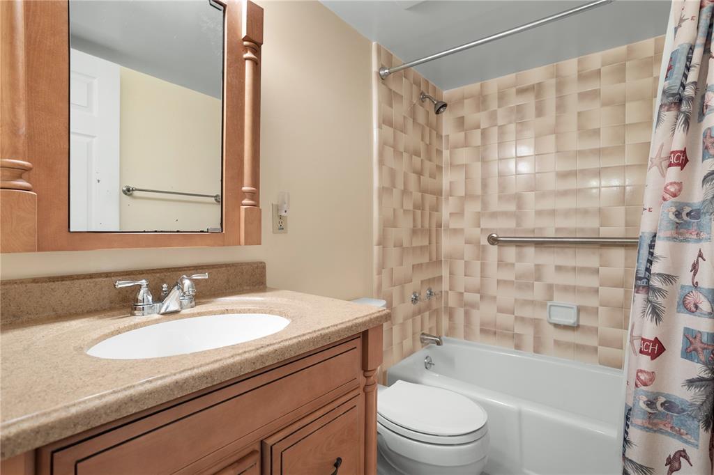 30 Inlet Harbor Road, Unit 5030 Ponce Inlet, FL 32127 - Photo 33 of 52 a bathroom with a granite countertop sink toilet and shower