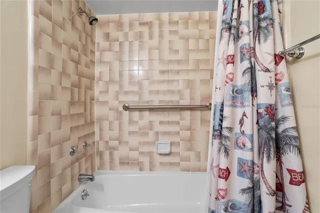 a bathroom with a bathtub and shower curtain