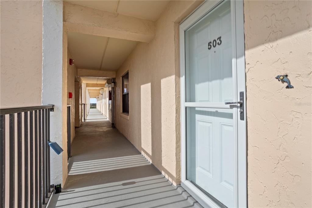 30 Inlet Harbor Road, Unit 5030 Ponce Inlet, FL 32127 - Photo 8 of 52 a view of a hallway with wooden floor and staircase