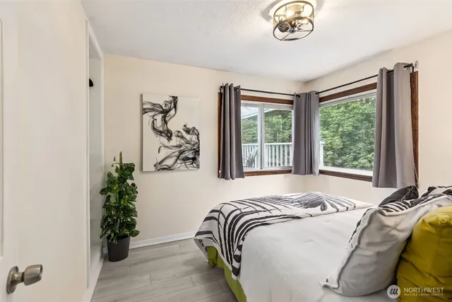 a bed sitting in a bedroom next to a window