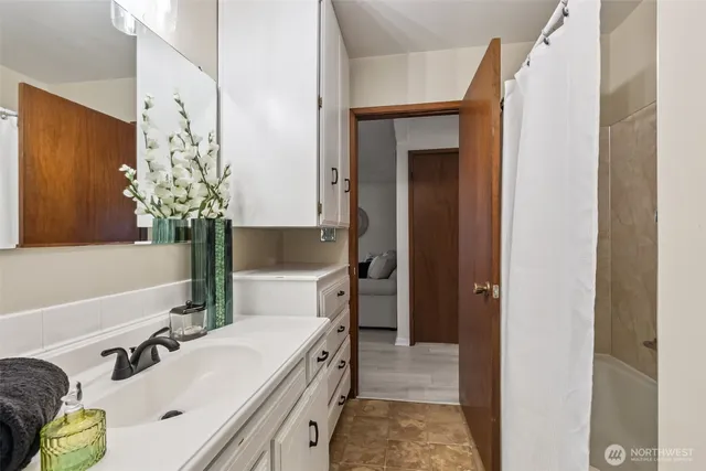 a bathroom with a sink a toilet and a mirror