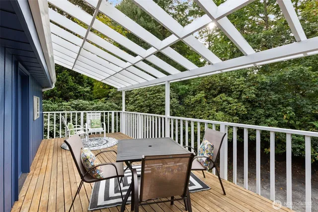 a view of a hallway with dining area and chandelier