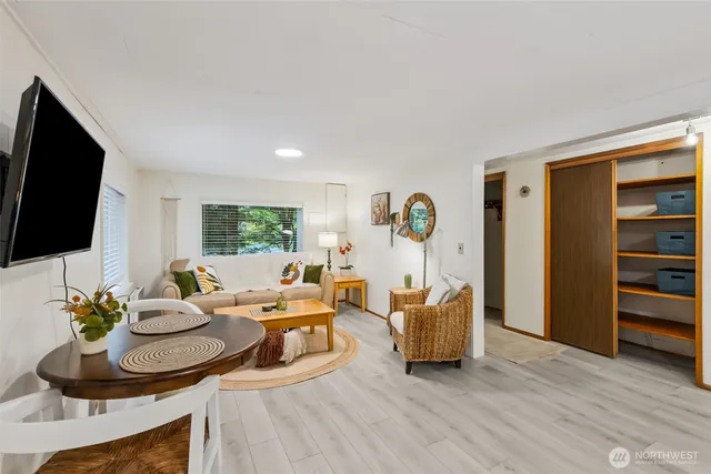 a living room with furniture flat screen tv and wooden floor