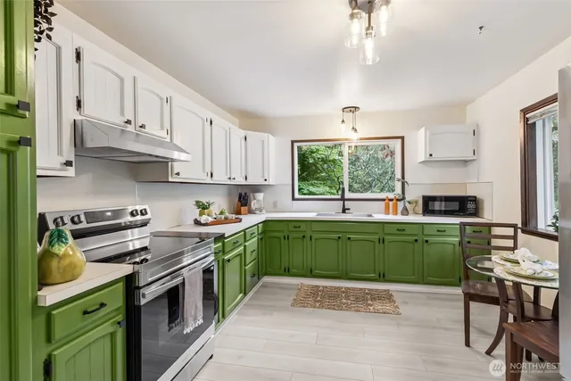 a kitchen with a stove a sink and a window