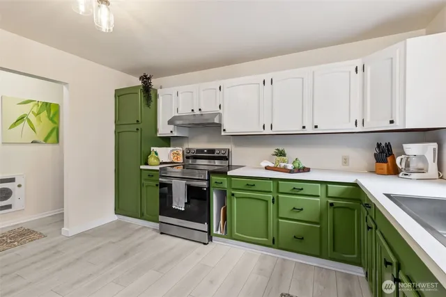a kitchen with a sink a stove and cabinets